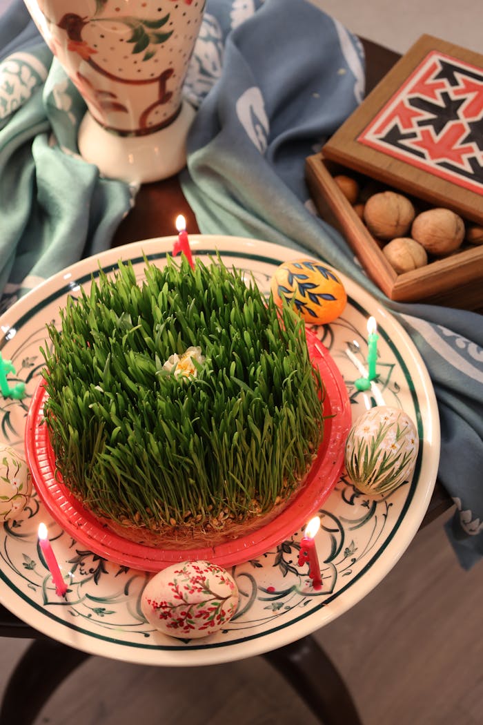 Traditional Nowruz table with sprouted wheat, decorated eggs, nuts, and candles, celebrating Persian New Year.
